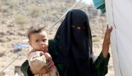 FILE PHOTO: A woman holds a child near the Mocha port on the Red Sea in Taiz, Yemen on March 1, 2017 (Abdulnasser Alseddik / Anadolu Agency) 