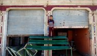 A displaced Iraqi boy stands as he plays outside a damaged buliding in western Mosul, Iraq, April 25, 2017. REUTERS/Ahmed Jadallah