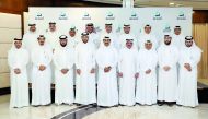 Qatar Petroleum (QP) employees pose for a group photo at the event.