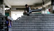 Workers rebulid a shop that was destroyed during fighting between Iraqi forces and Islamic state fighters, eastern Mosul, Iraq, April 21, 2017. REUTERS/ Muhammad Hamed