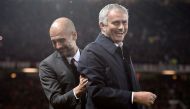(FILES) This file photo taken on October 26, 2016 shows Manchester United's Portuguese manager Jose Mourinho (R) and Manchester City's Spanish manager Pep Guardiola sharing a joke ahead of the English League Cup fourth round match between Manchester Unite
