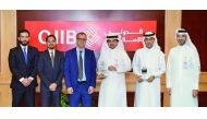 Abdulbasit Ahmad Al Shaibei, QIIB Chief Executive Officer (third right), Jamal Abdullah al-Jamal (second right), QIIB Deputy CEO and other officials pose for a group photo with the award at the event.