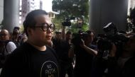 (FILES) This file photo taken on April 7, 2016 shows Scholarism activist Derek Lam (L) arriving at court in Hong Kong, where he had his charge of rioting during the Mong Kok protests withdrawn. AFP / Isaac Lawrence