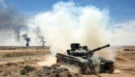 An Iraqi-modified T-72M tank belonging to the pro-government Hashed al-Shaabi (Popular Mobilization) paramilitary forces advances towards the UNESCO-listed ancient city of Hatra, southwest of the northern city of Mosul, during an offensive to retake the a