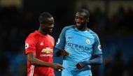 Manchester United's Ivorian defender Eric Bailly (L) talks with Manchester City's Ivorian midfielder Yaya Toure (R) at the end of the English Premier League football match between Manchester City and Manchester United at the Etihad Stadium in Manchester, 
