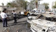 Iraqi policemen check the site of a blast which took place the previous day in the Iraqi capital Baghdad on April 29, 2017. A car bomb attack on the traffic police compound in central Baghdad killed at least three people and wounded seven, security and me