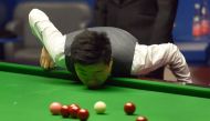 China's Ding Junhui contemplates a shot during the World Championship Snooker semi-final match against England's Mark Selby at The Crucible in Sheffield, England on April 28, 2017. / AFP / PAUL ELLIS
