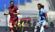 Roma's forward from Italy Francesco Totti (L) vies with Lazio's midfielder from Argentina Lucas Biglia during the Italian Serie A football match Roma vs Lazio at the Olympic Stadium in Rome on April 30, 2017. / AFP / FILIPPO MONTEFORTE