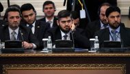 (FILES) This file photo taken on January 23, 2017 shows chief opposition negotiator Mohammad Alloush (C) of the Jaish al-Islam (Army of Islam) rebel group attending the first session of Syria peace talks at Astana's Rixos President Hotel.  AFP / Kirill KU