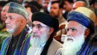 Afghan warlord Gulbuddin Hekmatyar (centre), former Afghan president Hamid Karzai (left) and former Jihadi leader Abdul Rabb Rasool Sayyaf attend a welcoming ceremony at the Presidential Palace in Kabul.