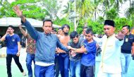 Plain clothes police recapture escaped inmates from the jail in Pekanbaru, Riau province, yesterday.