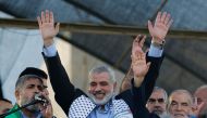 This file photo taken on August 27, 2014 shows Hamas leader in the Gaza Strip Ismail Haniya (C) waving to the crowd during a rally in Gaza City following a deal hailed by Israel and the Islamist movement as 'victory' in the 50-day war. AFP / Mohammed Abed