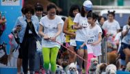 People run with their pets during a mini-marathon for dogs in Bangkok, Thailand May 7, 2017. REUTERS/Jorge Silva.