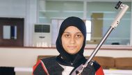 Qatari shooter Aisha Al Suwaidi poses for a photograph with her rifle. The 19-year-old believes reaching the 2020 Olympic Games and competing against the best is a 'realistic' goal.