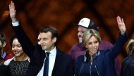 PARIS, FRANCE - MAY 07 : French presidential election candidate for the 'En Marche!' (Onwards!) political movement, Emmanuel Macron (L) greets with his wife Brigitte Trogneux (R) after winning the 2017 French election at the Esplanade du Louvre in Paris, 