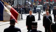 Outgoing French President Francois Hollande (R) and President-elect Emmanuel Macron attend a ceremony to mark the end of World War II at the Tomb of the Unknown Soldier at the Arc de Triomphe in Paris, France, May 8, 2017. REUTERS/Philippe Wojazer.