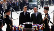 Outgoing French President Francois Hollande (R) and President-elect Emmanuel Macron attend a ceremony to mark the end of World War II at the Tomb of the Unknown Soldier at the Arc de Triomphe in Paris, France, May 8, 2017. REUTERS/Philippe Wojazer.