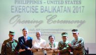 Officials link arms during the opening of the annual Philippine-US military exercises at Camp Aguinaldo, Quezon City, Manila, yesterday. 