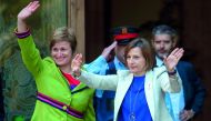 Catalan parliament President Carme Forcadell (R) and member of the Catalan parliament board Anna Simo wave upon their arrival at the TSJC (Superior Court of Catalonia) in Barcelona on May 8, 2017. Forcadell is charged with civil disobedience and misuse of