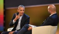 US former President Barack Obama (L) speaks with Sam Kass, food entrepreneur and former White House chef, during the third edition of 