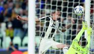 Juventus' Croatian forward Mario Mandzukic (left) scores a goal past Monaco's goalkeeper Danijel Subasic during the UEFA Champions League semi-final second leg football match played at the Juventus stadium in Turin yesterday. Juventus beat Monaco 2-1 and 