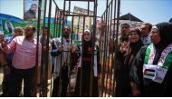 Gazaian Said Lulu (C-R) and Halud Dervis (C-L) stand behind a symbolic jail during their wedding ceremony at the tent, which is established for solidarity with hunger-striker prisoners at Israeli prisons at Saraya Square in Gaza City, Gaza on May 8, 2017.