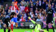 Real Madrid's midfielder Isco (left) scores a goal during the UEFA Champions League semifinal second leg football match against Club Atletico de Madrid at the Vicente Calderon Stadium in Madrid yesterday. Real Madrid secured their place in the Champions L