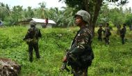 This photo taken on May 10, 2017 shows Philippine soldiers patrolling along a village near a highway in Maguindanao province, in southern island of Mindanao, after almost a week of attacks on members of the Bangsamoro Islamic Freedom Fighters (BIFF).   AF