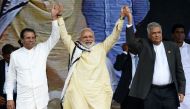 India's Prime Minister Narendra Modi (C) joins hands with Sri Lankan President Maithripala Sirisena (L) and Prime Minister Ranil Wickremesinghe (R) after addressing a public rally in the tea-growing town of Norwood, some 80kms east of Colombo on May 12, 2