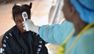 This August 16, 2014 photo shows a girl suspected of being infected with the Ebola virus having her temperature checked at the government hospital in Kenema, Sierra Leone  (AFP / CARL DE SOUZA) 
