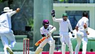 Pakistan wicketkeeper Sarfraz Ahmed (centre) successfully appeals for the wicket of West Indies batsman Kraigg Brathwaite after taking the catch off the bowling of Yasir Shah (right) during the third day's play of the third and final Test match at the Win
