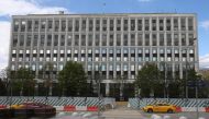 People drive vehicles in front of the Russian Interior Ministry building on May 13, 2017 in Moscow. Russia's interior ministry said on May 12, 2017 that some of its computers had been hit by a 