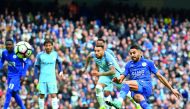 Leicester City's midfielder Riyad Mahrez (right) slips after taking his penalty, which hit his standing foot on the way to the goal, and was subsequently disallowed during the English Premier League match against Manchester City at the Etihad Stadium in M
