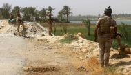 Members of the Iraqi government forces keep watch on August 15, 2016 in Dulab, in Haditha, west of Ramadi, the capital of Iraq's Anbar province, after pro-government forces recaptured the area from ISIS. / AFP / MOADH AL-DULAIMI.