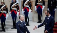 Newly-appointed French Prime Minister Edouard Philippe (R) reacts with his predecessor Bernard Cazeneuve (L) during a handover ceremony at the Hotel Matignon, in Paris, France, May 15, 2017. REUTERS/Benoit Tessier
