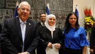 Israeli Justice Minister Ayelet Shaked (R) and Israeli President Reuven Rivlin (L) pose for a photo with Israeli Muslim Hana Khatib, the first woman in Israel to be appointed by an Israeli justice committee to become a religious judge, or qadi, in the cou