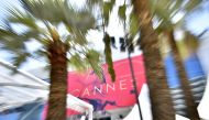 A picture taken on May 15, 2017 in Cannes, southeastern France, shows the affiche for the 70th Cannes Film Festival hanging from the facade of the Palais des Festivals along the top end of The Croisette. AFP / LOIC VENANCE
