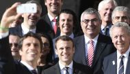 The co-president of the Paris bid for the 2024 Olympics Tony Estanguet (L, foreground) takes a selfie with new French President Emmanuel Macron (C), the president of the IOC Evaluation Commission for the 2024 Olympics Patrick Baumann (L) and French member