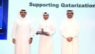 Minister of Energy and Industry, H E Dr Mohammed bin Saleh Al Sada (right) and Qatar Petroleum President and CEO Saad Sherida Al Kaabi (left), after handing over the memento to Nakilat Managing Director, Abdullah Al Sulaiti, for Qatarisation achievement. 