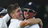 England’s Chris Woakes (left) celebrates with team-mate Alastair Cook during the third day of their first Test at Lord’s in London in this 2015 file picture.