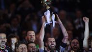 TOPSHOT - Juventus' defender from Italy Giorgio Chiellini holds the trophy with teammates Juventus' defender from Italy Leonardo Bonucci (L), Juventus' forward from Argentina Paulo Dybala (2ndL), Juventus midfielder Miralem Pjanic and Juventus' forward fr