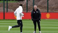 Manchester United's Portuguese manager Jose Mourinho (R) chats to Manchester United's French midfielder Paul Pogba during a team training session as part of a media open day at the club's training complex near Carrington, west of Manchester in north west 