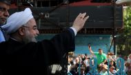 Iran's President Hassan Rouhani waves to supporters at a polling station during the presidential election in Tehran, Iran, May 19, 2017. President.ir