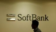 Man walks past the logo of SoftBank Group Corp at the company's headquarters in Tokyo (Reuters)