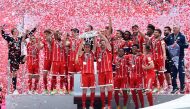 Bayern Munich's players celebrate with the trophy after the German first division Bundesliga football match FC Bayern Munich vs SC Freiburg, his last match for the club, in the southern German city of Munich on May 20, 2017.  AFP / Christof Stache