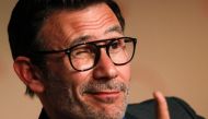 French director Michel Hazanavicius gives the thumbs-up while attending on May 21, 2017 a press conference for the film 'The Redoubtable (Le Redoutable)' at the 70th edition of the Cannes Film Festival in Cannes, southern France.  AFP / Laurent Emmanuel