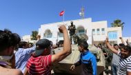 Unemployed Tunisian protesters shout slogans during a demonstration outside the Tataouine governorate headquarters on May 22, 2017, in Tataouine, around 500 kilometres (300 miles) south of Tunis.  AFP / FATHI NASRI
