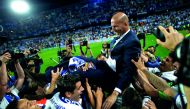 Real Madrid coach Zinedine Zidane is carried by his players as they celebrate after winning La Liga title on Sunday.   
