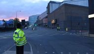 Police stand guard at the scene of a suspected terrorist attack during a pop concert by US star Ariana Grande in Manchester, northwest England on May 23, 2017. / AFP / PAUL ELLIS