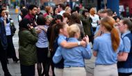 Retail staff hug each other after being evacuated from the Arndale Centre shopping mall in Manchester, northwest England on May 23, 2017 following a security alert the day after a deadly terror attack at the Manchester Arena. AFP / Ben STANSALL
